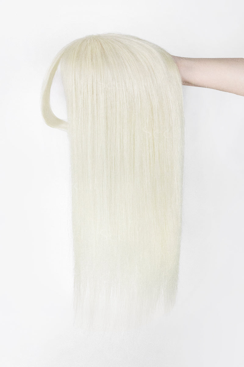 A long, straight platinum blonde wig with a side part, held up by a person&