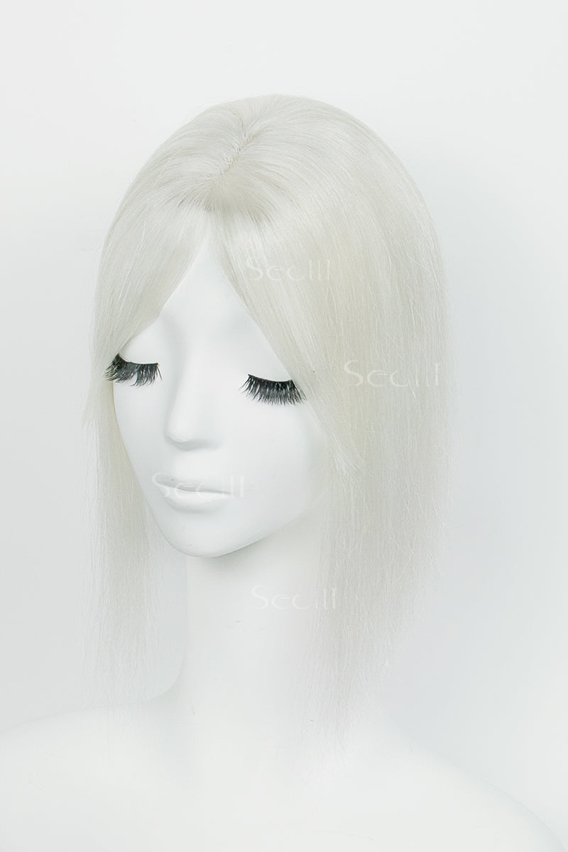 A silver grey white human hair topper with bangs displayed on a mannequin head.